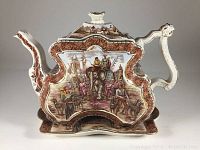 Side view of the teapot showing transfer decoration depicting Indian scene with elephant and riders, bordered by reddish-brown floral pattern with gilded edges