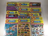 Front view showing multiple packs with visible labels like Sticker Activity Pack, various themes including planes and trains.