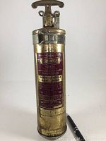 Front view of the vintage magnesium fire extinguisher showing the label with the brand 'Chemetall' and usage instructions.