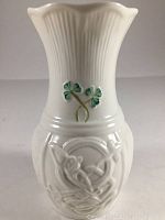 Front view of the small white porcelain vase showing shamrock embellishments and embossed Celtic designs