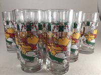 Front view showing multiple glasses with Winnie The Pooh and Tigger sledding and candy canes decoration.