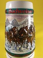 Front view showing the team of horses pulling the coach with mountain backdrop and snow.