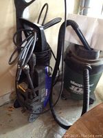 Simoniz power washer and Shop Vac viewed together showing item condition and components.
