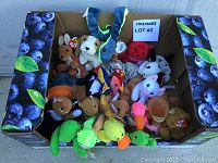 Photo showing assortment of new TY Beanie Babies packed in a cardboard box, each with a TY tag mostly visible.