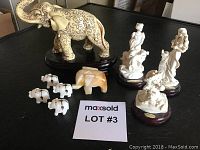 Photo showing all items in the lot: 2 porcelain Giuseppe Armani figurines, 1 large decorated hard plastic elephant, 1 small hand-carved marble elephant, and 4 small white elephant figurines.