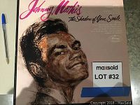 Photo of Johnny Mathis LP record "The Shadow of Your Smile" showing album cover artwork and title.