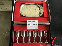 Six silverplated stemmed aperitif vessels and an oval silverplated tray in red-lined box