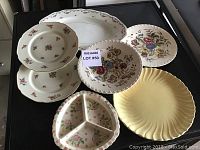 Overview of six plates and platters showing various floral designs and styles.