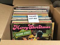 Box of assorted vintage LP records with visible cover for Merry Christmas from Sesame Street album