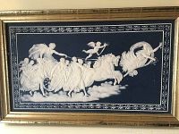 Front view of framed plaque showing white relief of Aurora and figures on dark blue background
