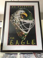 Framed poster showing an illustrated hockey goalie mask painted as an eagle signed by Ed Belfour with text 'THE EAGLE'