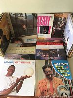 Photo showing a collection of vintage vinyl records including Bill Cosby albums and Gordon Lightfoot "A Lightfoot Collection" sealed box