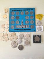 Photo showing the Canadian Prime Ministers commemorative medallions set in blue display and additional individual medallions around it.