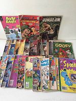 Photo showing full group of 23 comic books with varied colorful covers and themes including humor, military, jungle adventure, and Disney.