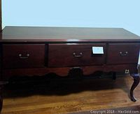 Front view of the mahogany breakfront sideboard showing two deep drawers and curved legs.
