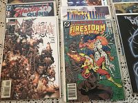 Top view of 14 comic books in clear protective covers, showing several titles including Harley Quinn, Steamboyns, Firestorm, Record of Lodoss War, and others