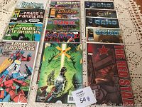 Photo showing 15 comic books including Transformers, Saint Angel, Knuckles, Shidima, Sonic the Hedgehog, Echo, Vampir, The Red Star, and Universe X.