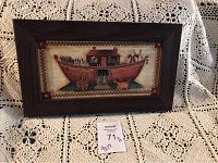 Photo of the framed Noah's Ark picture showing the entire artwork and frame on a lace cloth background.