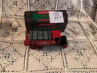 Side view of the Texaco 1925 Kenworth stake truck die cast coin bank showing barrels and locking mechanism.