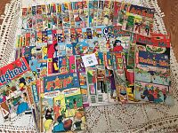 Stack of colorful Archie comic books, showing various titles including Archie, Betty and Me, Jughead, Pep, and Betty & Veronica with wear.