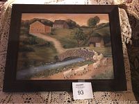 Full view of the framed pastoral landscape painting including stone bridge, sheep, path, and cottages.