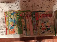 A selection of Richie Rich comic books arranged in a row showing colorful front covers with Richie Rich character and different scenes