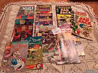 Overview of all comic books in the lot laid out on a crocheted tablecloth showing the full collection