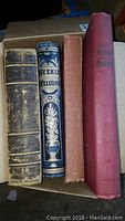 Four antique books side-by-side showing spines and bindings in varying conditions as described.