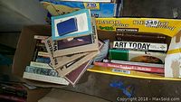 Box containing over 20 art books including 'George Catlin and his Indian Gallery', 'Art Today', and 'The Impressionists'