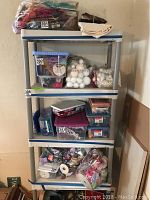 Front view of the plastic shelving unit with various items stored on shelves (items not included).