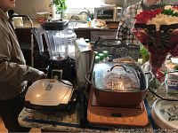 Copper Chef induction cooker with manual, Wolfgang Puck blender, and George Foreman grill on countertop.