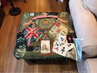 Top view of the embroidered art featuring regimental flags and floral embroidery with patches and old photo placed on top.