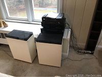 Stereo audio equipment including speakers positioned by window, showing overall lot.