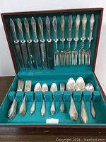 Full view of open wooden box containing the Holmes and Edwards silver plate flatware set, arranged neatly in velvet slots showing all pieces.