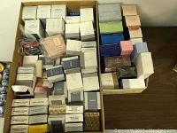 Overview of large assortment of vintage Avon perfume and cologne boxes, all sealed and new in box.
