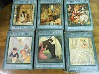 Six vintage 1920s My Bookhouse volumes with illustrated paper front covers showing story scenes.