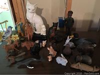 All figurines displayed on a wooden table, showcasing variety and size differences