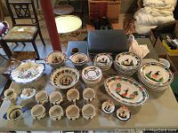 Overview of all pieces on table including plates, bowls, cups, saucers, platter, bag holders and creamer
