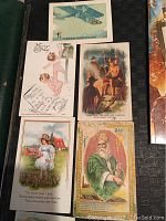 Photo showing vintage Christmas cards with classic illustrations including children, angels, airplanes, and biblical scenes.