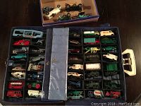 Top view of carrying case filled with compartments and vehicles