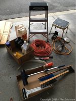 Overview photo of Werner aluminum step ladder, extension cords, assorted tools, oils, funnels, and a stool in a garage setting.