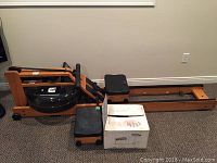 Full view of assembled water rower with front box containing extra parts