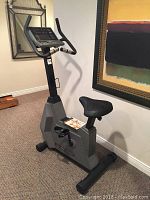 Full view of upright stationary bike against wall