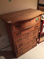 Side angled view of entire chest showing wood grain, drawer handles, and overall condition.