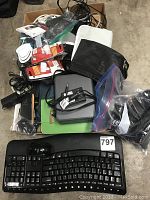 Overview of mixed electronics and accessories including keyboard, headphones, cables