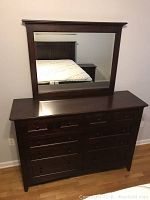 Dresser with attached matching mirror, showing top and drawer fronts, dark cherry mahogany wood finish.