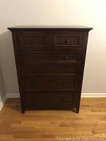 Front view of dresser showing six drawers and cherry finish