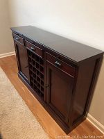 Angled left view showing entire buffet with side cabinet, central wine grid, and right cabinet