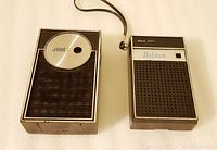 Photo showing two 1960s transistor radios, one 'Jane' and one 'Belson', both showing their front speaker grills and tuning controls