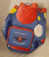 Photo of a colorful British Airways 1990s kid's travel bag, showing front pocket with logo and drawstring.